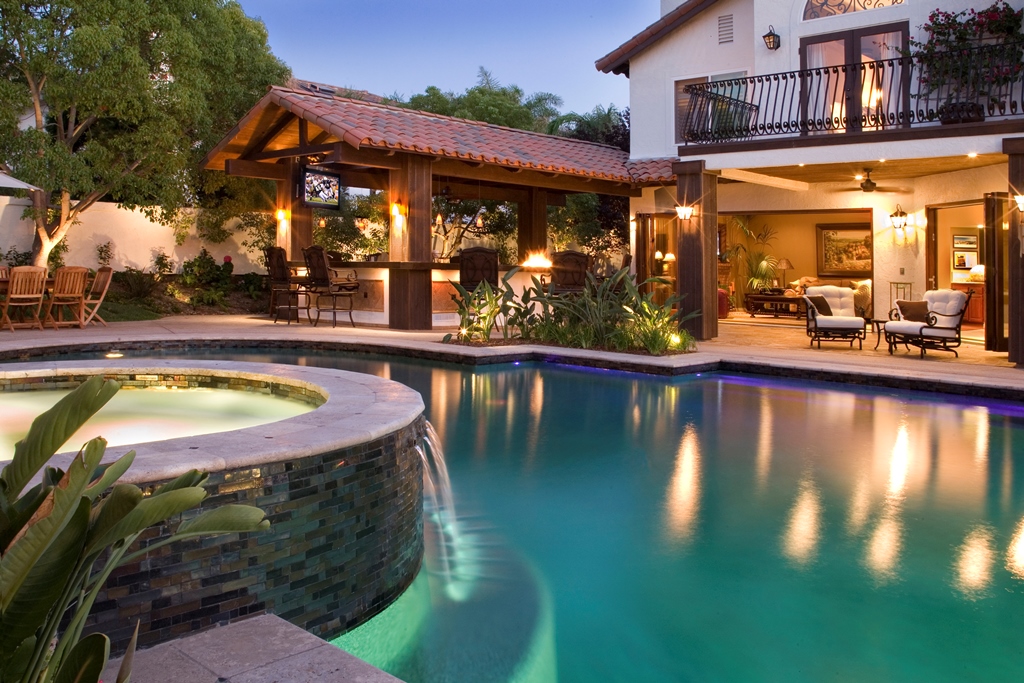 The covered section beyond is the new outdoor kitchen with a large bar and firetable.