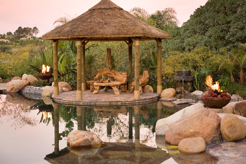 To get the palapa's posts to the edge of the pool we engineered custom welded baseplates that split the posts like a blade, hidden beneath the rope detail.