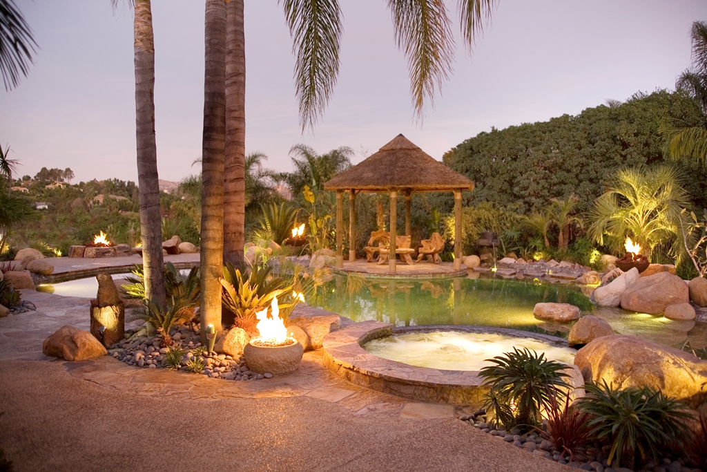 The fire elements include a natural rock ring, a small stone urn filled with broken glass, and a pair of rusted bowls that look a bit like large gold-panning dishes.